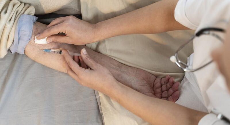 Doctor Vaccinating Senior Patient